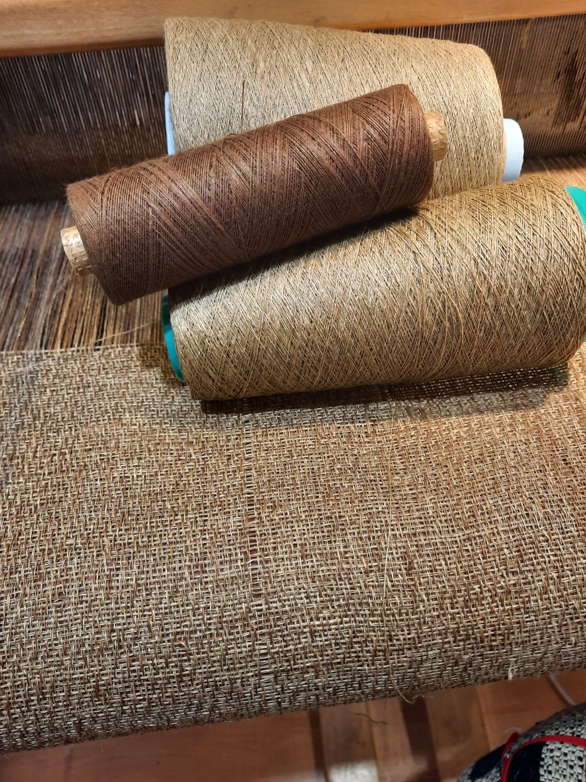Bespoke upholstery fabric with reels of thread